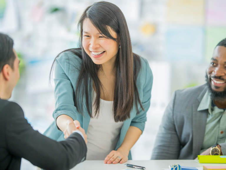 Two people shaking hands to set up a commercial co-venture.